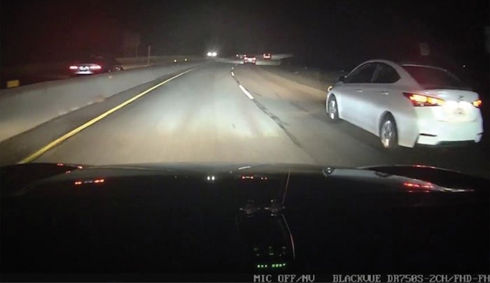  The tail lights and back end of a car being driven the wrong way on Highway 1 in West Vancouver Monday evening - in the upper left corner of the photo - were captured by the dash cam of a vehicle heading east. Photo courtesy West Vancouver Police Department