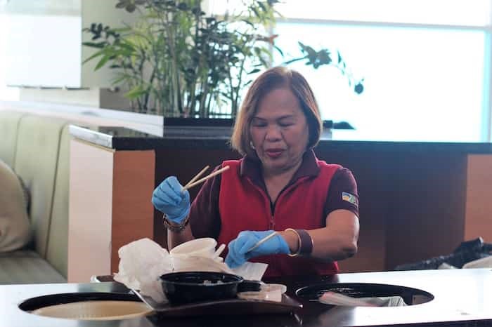  Janitorial staff at Aberdeen Centre help sort chopsticks from food court trays. Photo: Alyse Kotyk