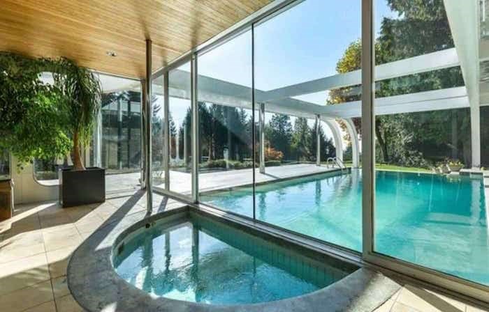  The outdoor pool is on the other side of the glass wall from this indoor hot tub. Listing agent: Eric Latta