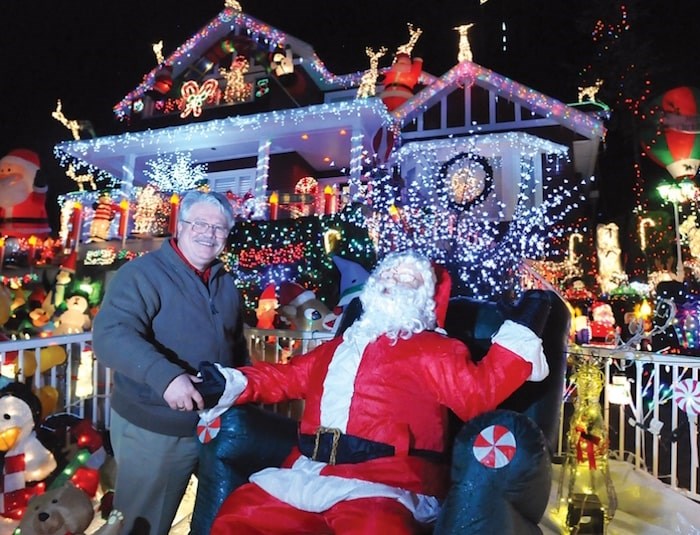  John Ribalkin stands in front of his festive home decked out for charity, at 4967 Chalet Pl., during a previous holiday season. Photo by Paul McGrath, North Shore News