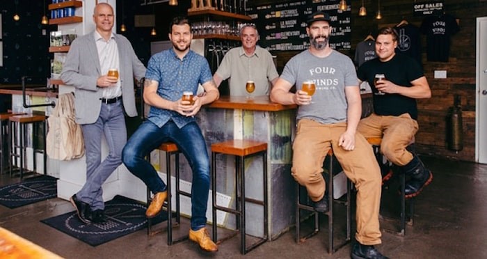  Pictured from left: Sean Hodgins, president of Century Group, Adam Mills, sales and marketing director and co-founder of Four Winds Brewing Company, Greg Mills, co-founder, Brent Mills, brew master and co-founder, and Kylo Hoy, head brewer. File photo.