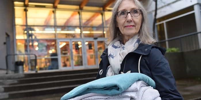  Penny Rogers with an armload of towels at Kitsilano Community Centre, where she and 40 other volunteers have helped run a shower program for the area’s homeless population for 18 years.