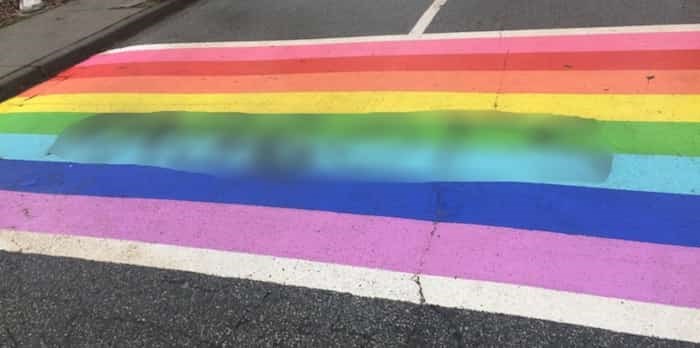  A homophobic slur was spraypainted on the rainbow crosswalk at Moscrop school. The NOW has chosen to blur out the offensive word due to it hateful nature. photo contributed