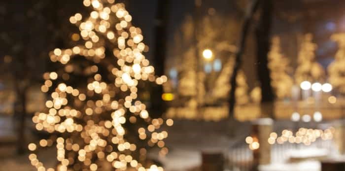  Christmas tree with lights glowing / Shutterstock