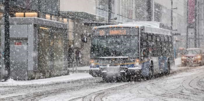  Vancouver, CANADA - 23 Feb, 2018 : Translink bus in Vancouver still operate in winter while it has snow storm in Downtown Vancouver, Canada / Shutterstock