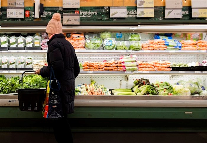  A women overlooks produce in a grocery store in Toronto on Friday, Nov. 30, 2018. An annual report estimates the average Canadian family will pay about $400 more for groceries and roughly $150 more for dining out next year. THE CANADIAN PRESS/Nathan Denette