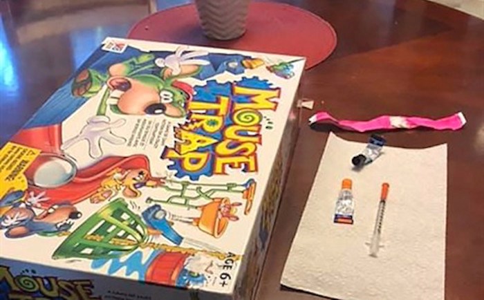  A board game, syringe and glue are seen in this undated handout photo. A father in Pitt Meadows, B.C., says the last thing his family expected to find inside a second-hand board game was a syringe and toxic glue. THE CANADIAN PRESS/HO, Mitch Selman
