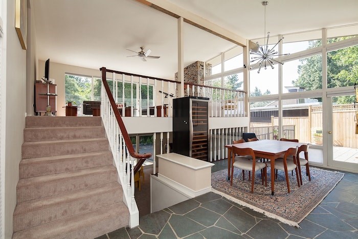  The dining room is one half-level down from the upper living space, and benefits from soaring ceilings and tonnes of natural light. Image supplied