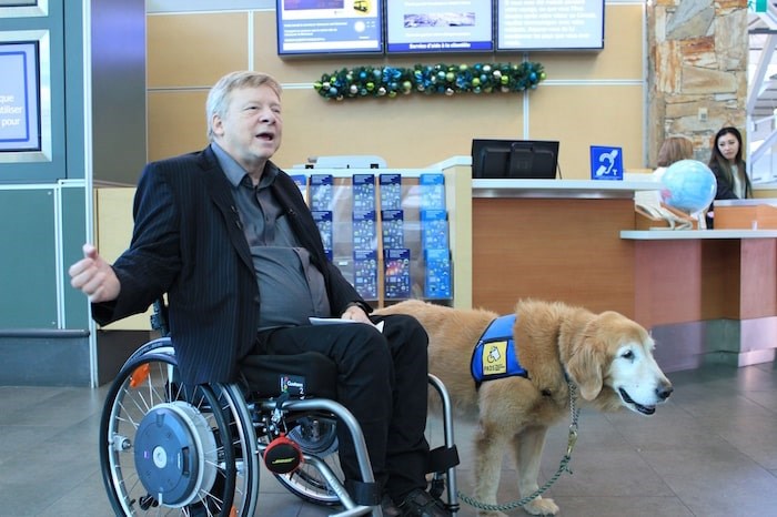  Brad McCannell, vice president of access and inclusion at the Rick Hansen Foundation, explains that service counter and information screen heights all help the airport be more accessible. Photo: Alyse Kotyk