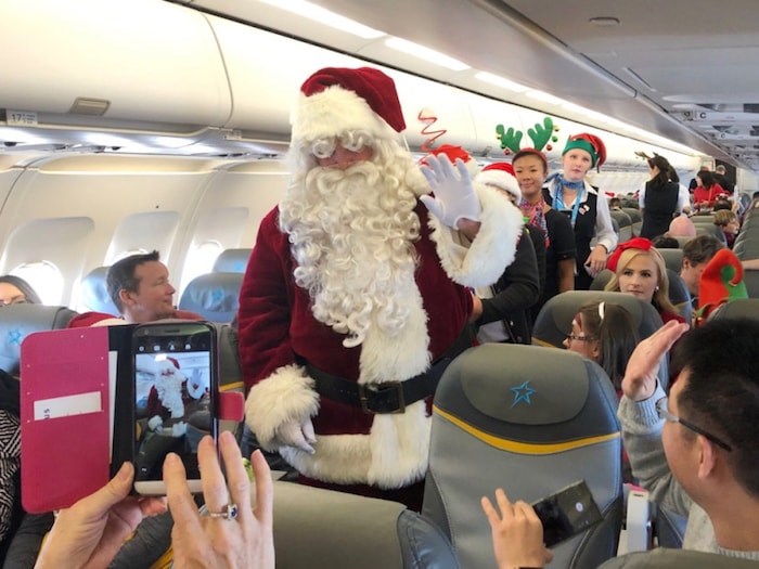  Santa makes his way through the plane on the 14th annual Flight with Santa, a partnership between Air Transat and the Children's Wish Foundation. About 30 wish kids and their families took to the skies Dec. 5 on a mission to find Santa and bring him back to Vancouver. Photo Jessica Kerr