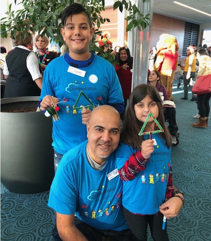  Maya Ahuja, 8, with her dad Gary and older brother Danny, 11, waiting to board the Flight with Santa. Photo Jessica Kerr