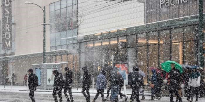  Vancouver, CANADA - 23 Feb, 2018 : People walk across the road while winter time with Snow storm in Downtown Vancouver, Canada Winter time with Snow storm in Downtown Vancouver, Canada / Shutterstock