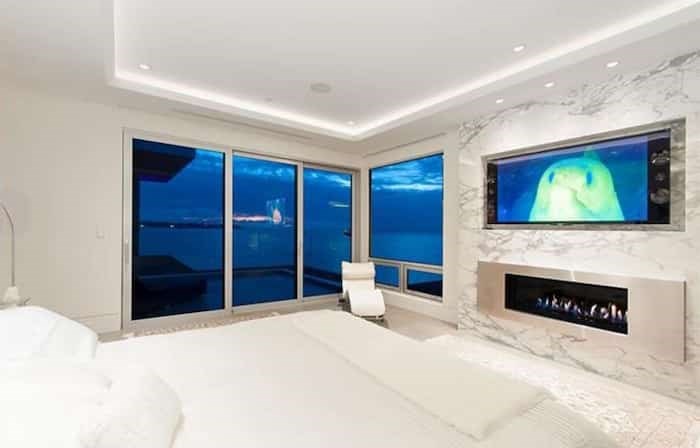  The master bedroom has a contemporary linear fireplace with more marble on the huge surround. Listing agent: Nafiseh Samsam