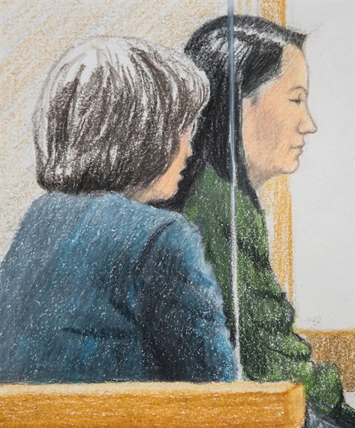  In this courtroom sketch, Meng Wanzhou, back right, the chief financial officer of Huawei Technologies, sits beside a translator during a bail hearing at B.C. Supreme Court in Vancouver, on Friday December 7, 2018. THE CANADIAN PRESS/Jane Wolsak