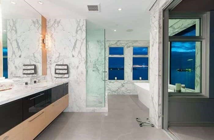  The incredible master bathroom has a tub with epic views, and a concertina door to a private upper deck. Listing agent: Nafiseh Samsam