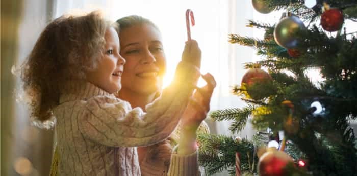  Mother and daughter celebrate Christmas in a decorated house with a Christmas tree / Shutterstock