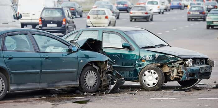  car crash accident on street, damaged automobiles after collision in city / Shutterstock