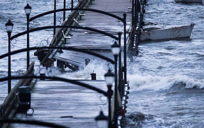  A boat is battered by waves and slammed into the White Rock Pier that was severely damaged during a windstorm, in White Rock, B.C., on Thursday December 20, 2018. One person who was trapped on the pier had to be rescued by helicopter. THE CANADIAN PRESS/Darryl Dyck