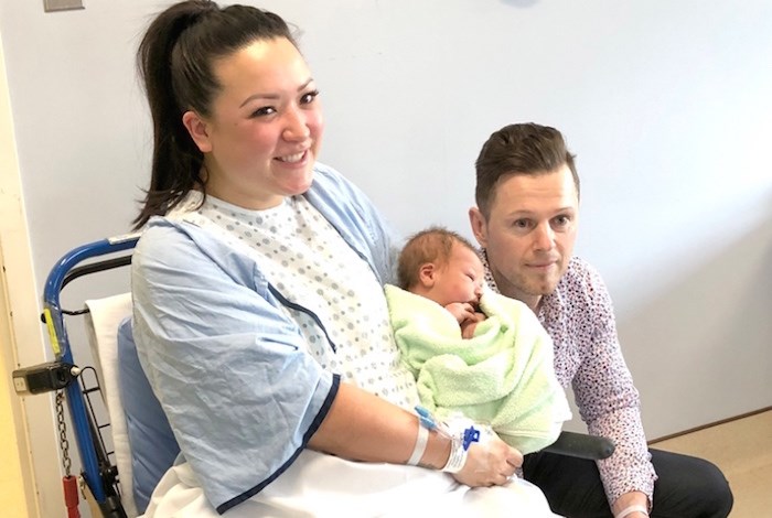  Baby Dominik Soswa with tired parents Janet Shimizu and Lukasz Soswa. Photo by Chris Campbell.