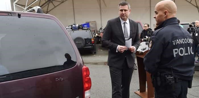  Vancouver police Sgt. Mike Heard, who is heading the investigation into the Jan. 13, 2018 shooting that killed 23-year-old Kevin Whiteside and 15-year-old Alfred Wong, and media relations officer Const. Jason Doucette stand next to the vehicle investigators believe was involved in the incident. Photo Dan Toulgoet