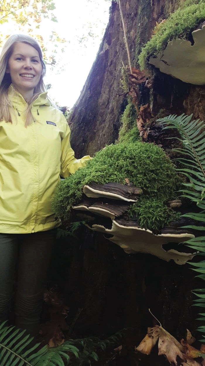  Andrea Inness by a huge “conk” mushroom covered in moss in the Mossome Grove. Photo by Ken Wu