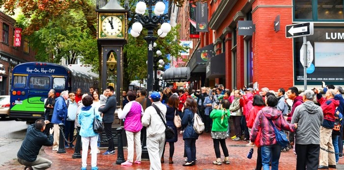  Tourists gather around Steam Clock sound the hour in Vancouver's historic Gastown district (i viewfinder / Shutterstock.com)