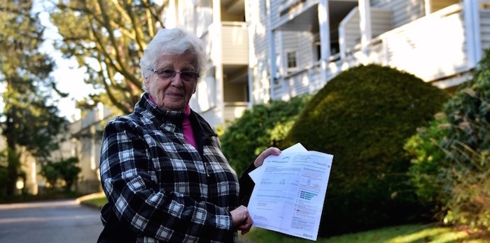  Louise McManus stands outside her condo on Moffatt Road holding her letter from BC Assessment. Her home's assessed value jumped by 37 per cent since last year, more than four times the city-wide average for condos. Photo: Megan Devlin/Richmond News