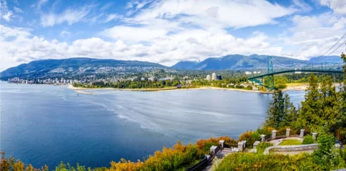  Vancouver skyline panorama taken at Prospect Point in Stanley Park with Lions Gate Bridge on right and West Vancouver on left. / Shutterstock