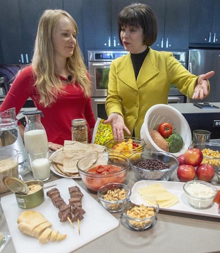  Health Minister Ginette Petitpas Taylor, right, and nutritionist Jessica Cole look over samples of some of the food groups at the unveiling of Canada's new Food Guide, Tuesday, January 22, 2019 in Montreal.THE CANADIAN PRESS/Ryan Remiorz