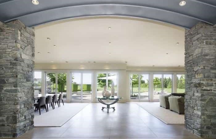  This grand foyer leads into the great room, and showcases the home's Modernist styling, such as stone interior walls and clean lines. Listing agent: Manyee Lui