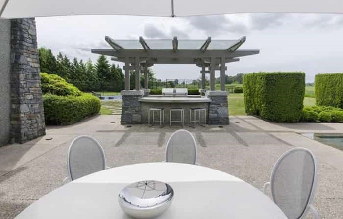  The outdoor kitchen comes complete with entertainment bar, and there's an al-fresco dining area nearby. Listing agent: Manyee Lui