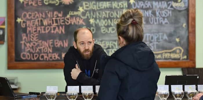 Evergreen Cannabis dispensary employee Stephen Lebovitis helps a customer on a Friday afternoon in late January.