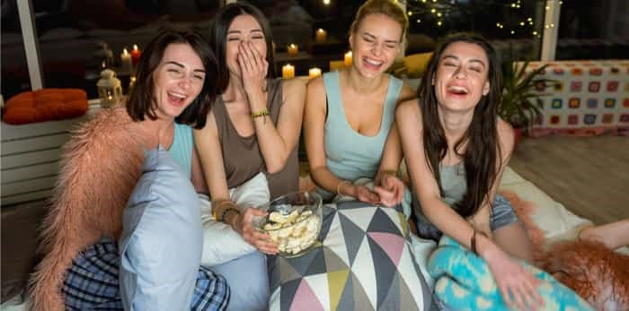  girls laughing watching a movie / Shutterstock
