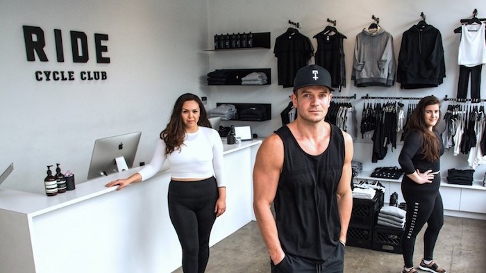  Serial entrepreneur and fashion industry scion JJ Wilson (centre) showing some of his clothing line along with staffer Diana Claxton (left) and assistant store manager Stephanie Stipancik. Wilson has launched his first clothing line independently of his family. Photo by Chung Chow.