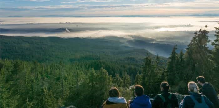  Group of hikers enjoying the panoramic view over the clouds from dog mountain in Vancouver on a sunny afternoon / Shutterstock