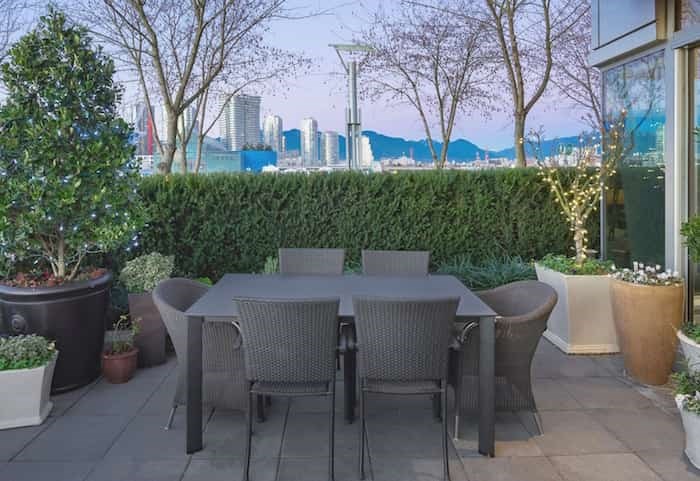  The main patio off the great room of this luxurious unit offers direct access to the False Creek seawall. Listing agents: Mike Rampf and Shawn Anderson