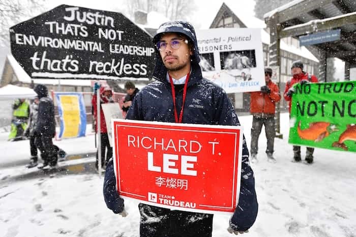  Liberal volunteer Alexander Garcha stands in front of anti-pipeline protesters outside the Shadbolt Centre for the Arts ahead of a campaign event featuring Prime Minister Justin Trudeau. - Jennifer Gauthier