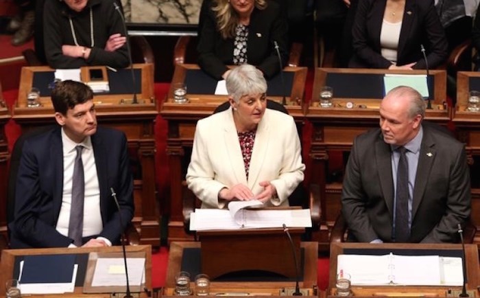  Attorney General David Eby, left and Premier John Horgan look on as Finance Minister Carole James delivers the budget speech at the legislature in Victoria today.