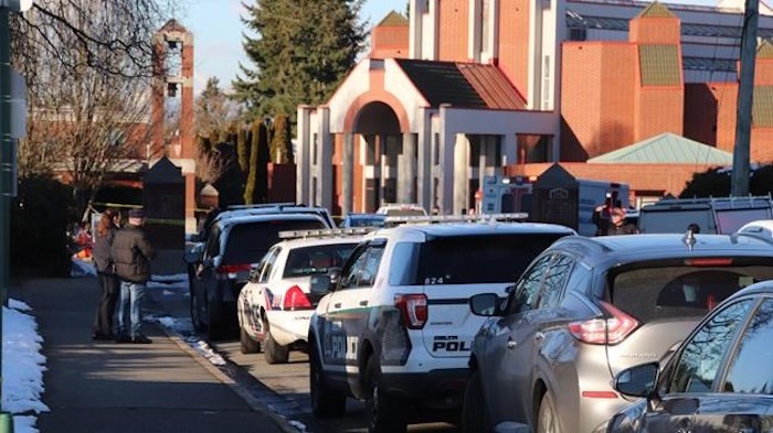  First responders stand outside Immaculate Conception elementary school in Delta, B.C. on Wednesday Feb. 20, 2019. Police say an off-duty officer and a woman were stabbed outside a private elementary school. THE CANADIAN PRESS/Shane MacKichan