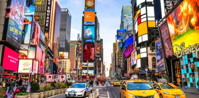  NEW YORK CITY - DEC 01 Times Square is a busy tourist intersection of neon art and commerce and is an iconic street of New York City and America, December 01th, 2013 in Manhattan, New York City / Shutterstock