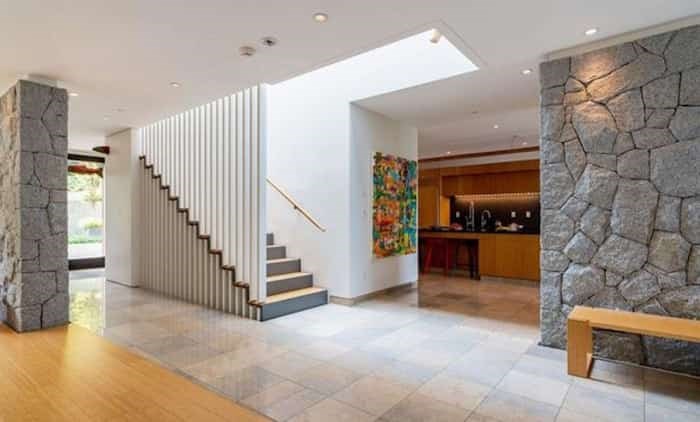  The Modernist touches continue with more interior rock walls and this linear staircase. Listing agent: Faith Wilson