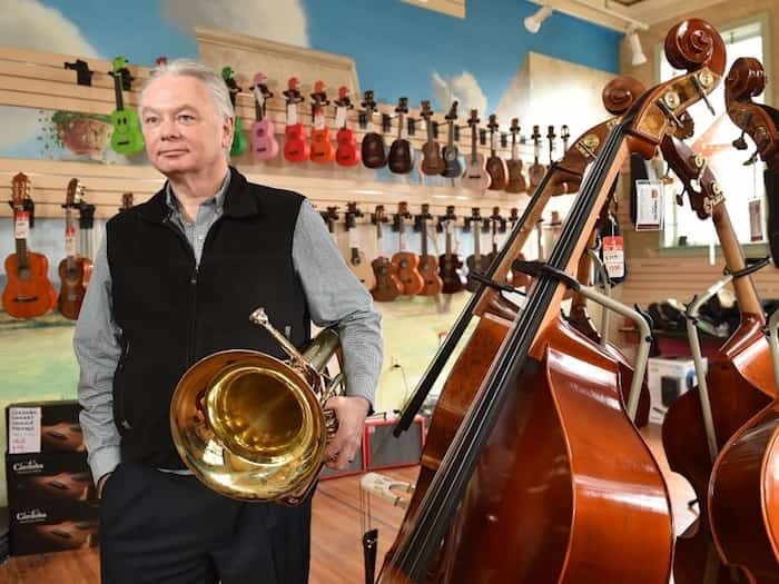  Tapestry Music owner David Sabourin stands alongside a euphonium at his West Broadway business, which will re-locate in April.Photograph By DAN TOULGOET