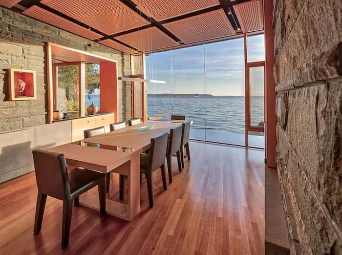  The dining room displays exposed stone on its interior walls, a detail that is characteristic of Mid-century Modern architecture. Listing agent: Christa Frosch