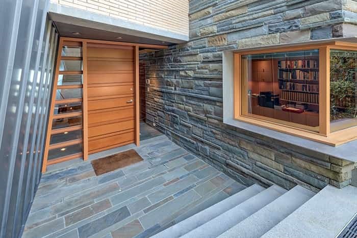 The entrance of this architecturally striking home displays the juxtaposition of materials including Pennsylvania Bluestone, concrete, brick, zinc and wood. Listing agent: Christa Frosch