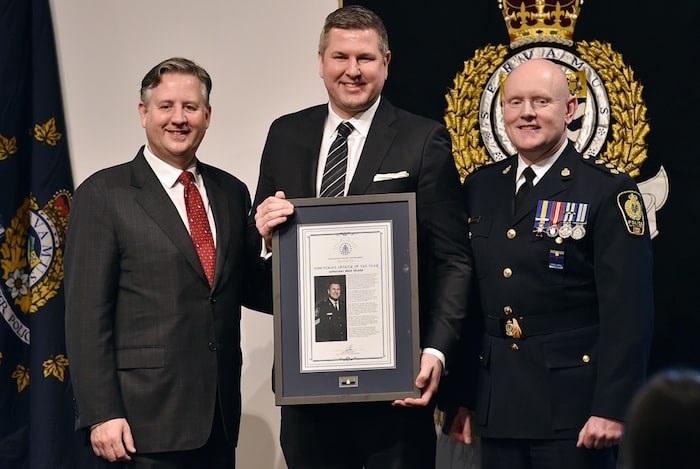  Sgt. Mike Heard receives his Police Officer of the Year award from Chief Adam Palmer and Mayor Kennedy Stewart. Photo Dan Toulgoet