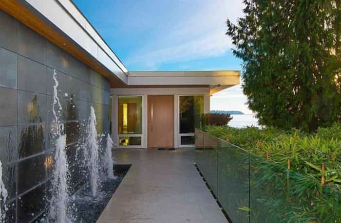  The elegant front entry, complete with a row of fountains, is on the upper level of the home, as is the parking garage. Listing agent: Nafiseh Samsam