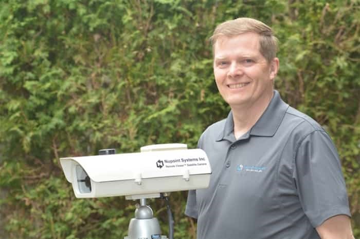  Delta's Nupoint Systems president Wayne Carlson with heir unique satellite camera that monitors remote environments. Photograph submitted.