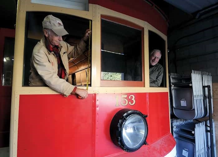  Dave Walmsley and Blaine Thompson lean out the windows of Streetcar No. 153, which first hit Lonsdale Avenue 111 years ago. - photo Mike Wakefield, North Shore News
