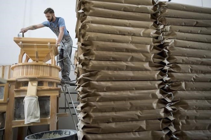  Christian Bendsen, production manager and head miller of Flourist works the stone mill at their production facility in Vancouver, Friday, April, 5, 2019. Flourist and other fresh flour producers have seized on rising demand for whole, traceable baking ingredients, as well as a stronger connection between consumers and farmers. THE CANADIAN PRESS/Jonathan Hayward