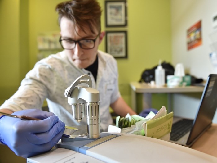  B.C. Centre on Substance Use drug checking operational technician Jeremy Kalicum tests a bag of MDMA, commonly known as ecstasy, at the Robert and Lily Lee Community Health Centre on April 12. Photo by Dan Toulgoet.